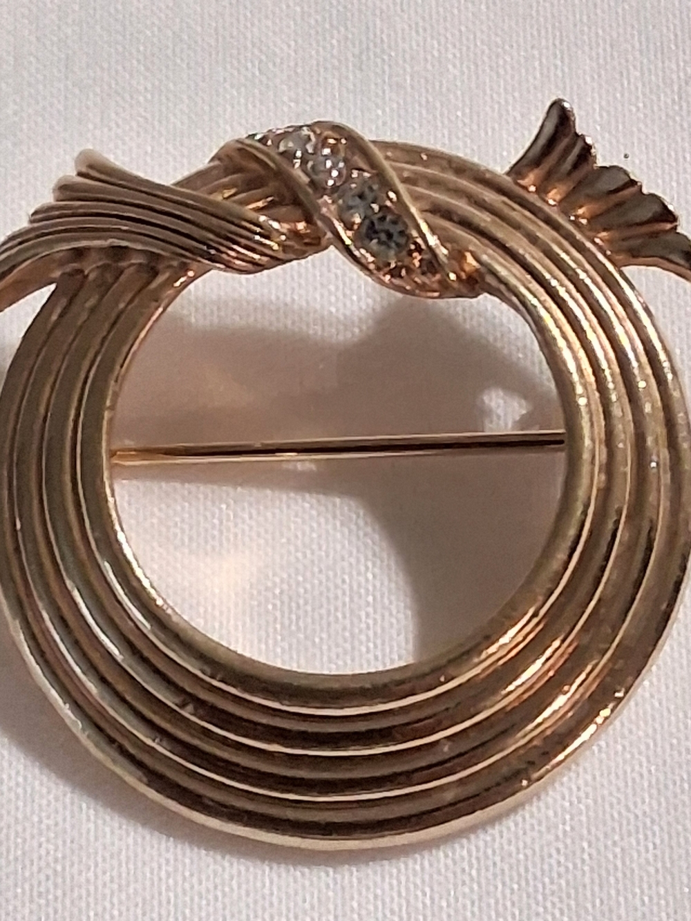 Avon Gold-Tone Circular Ribbon Wreath Brooch with Rhinestones